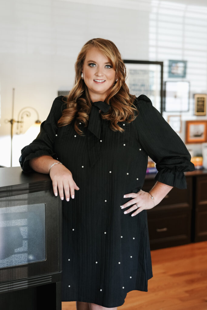 Headshot of team member Christy in black dress